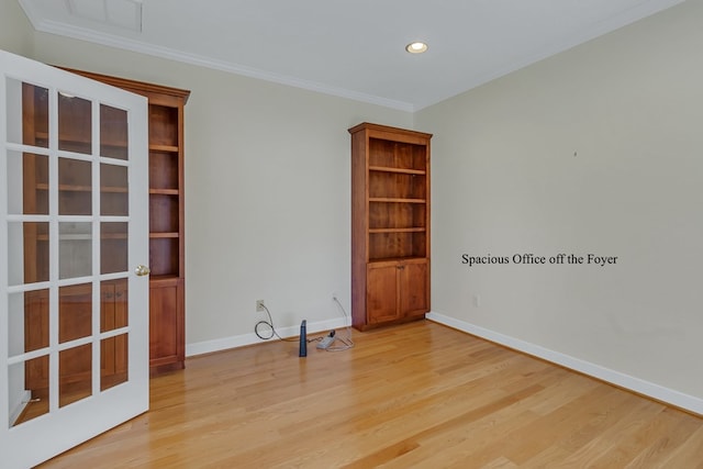 empty room featuring light hardwood / wood-style flooring and ornamental molding