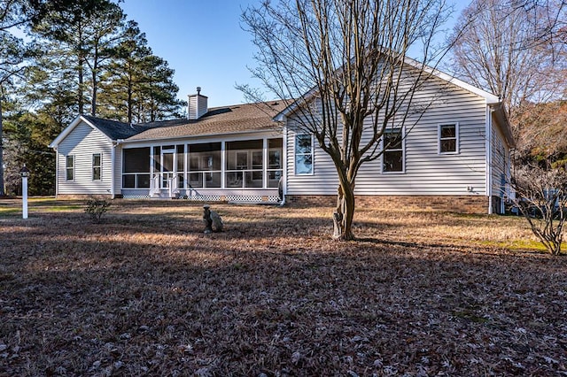 rear view of property with a sunroom