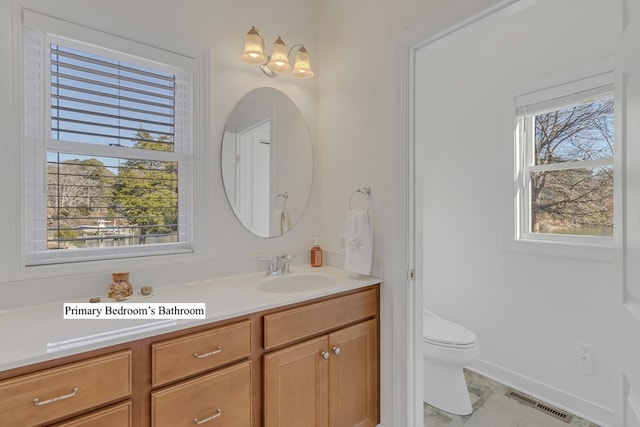 bathroom with tile patterned floors, vanity, and toilet