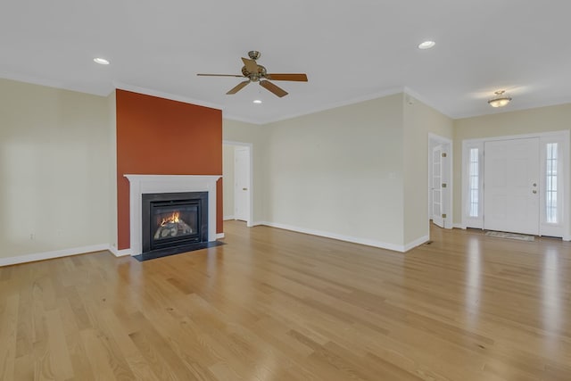 unfurnished living room featuring ceiling fan, light hardwood / wood-style floors, and ornamental molding