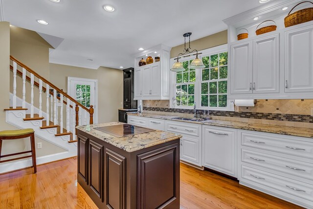 858 Harmony Hills Cir, Heathsville, VA 22473 - kitchen featuring white cabinets, backsplash, light stone counters, arched walkways, and hanging light fixtures