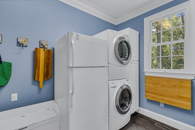 858 Harmony Hills Cir, Heathsville, VA 22473 - laundry area with stacked washer and clothes dryer, crown molding, and healthy amount of natural light