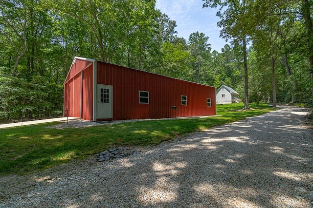 858 Harmony Hills Cir, Heathsville, VA 22473 - view of side of property with a pole building, an outbuilding, a yard, and gravel driveway