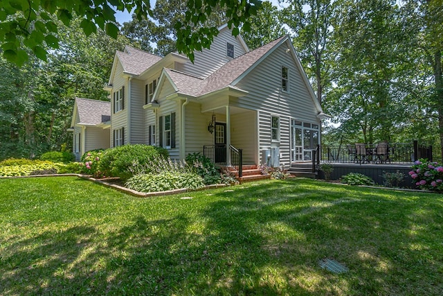 858 Harmony Hills Cir, Heathsville, VA 22473 - view of front of house featuring roof with shingles, a front lawn, and a deck
