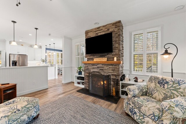 living room featuring plenty of natural light and ornamental molding