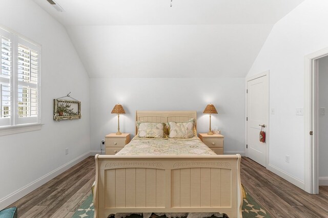 bedroom with visible vents, lofted ceiling, and wood finished floors