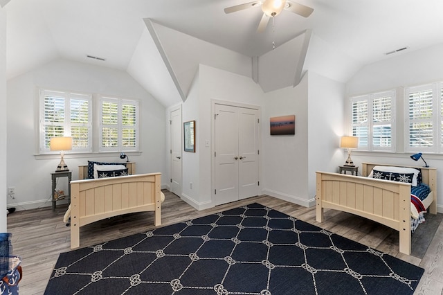 bedroom featuring vaulted ceiling, wood finished floors, and visible vents