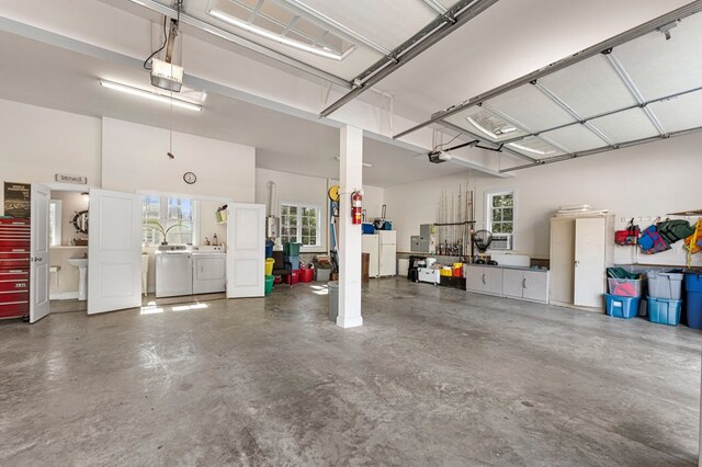 garage featuring a garage door opener and independent washer and dryer