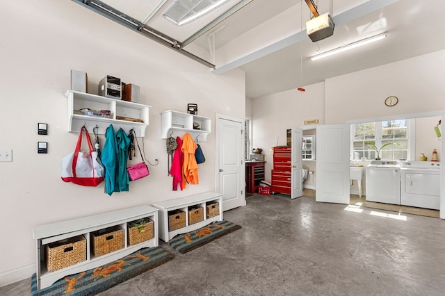 garage featuring separate washer and dryer and a garage door opener