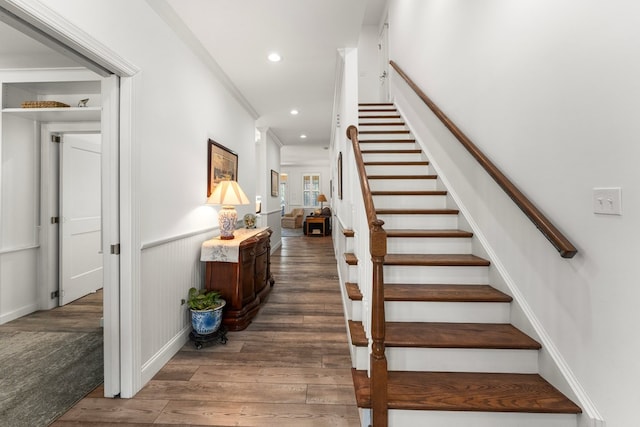 stairs featuring recessed lighting, wainscoting, crown molding, and wood finished floors