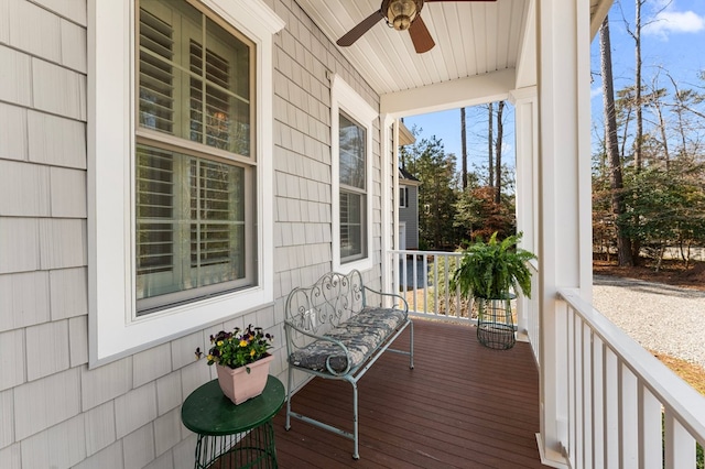 wooden terrace with covered porch and ceiling fan