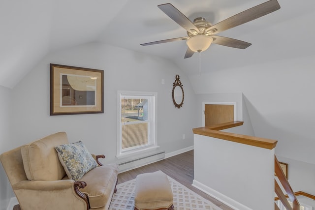 sitting room with ceiling fan, a baseboard radiator, lofted ceiling, and hardwood / wood-style flooring