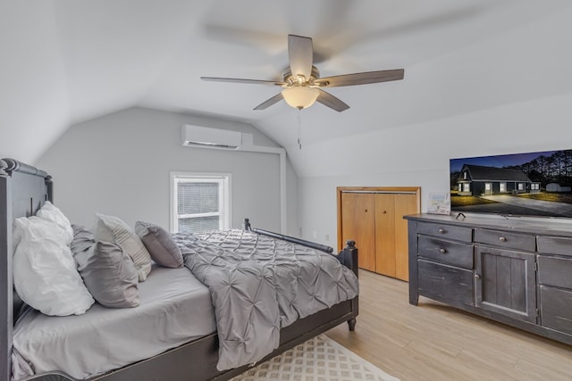 bedroom with light hardwood / wood-style floors, a wall unit AC, ceiling fan, and lofted ceiling