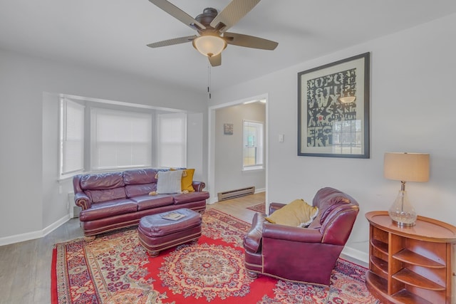 living room with hardwood / wood-style flooring, ceiling fan, and a baseboard radiator