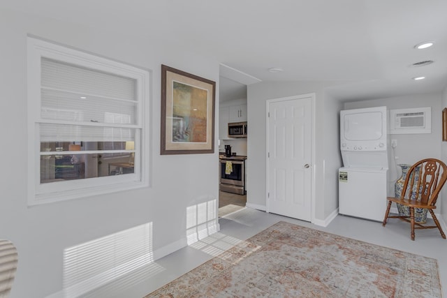 entryway featuring stacked washer and dryer and lofted ceiling