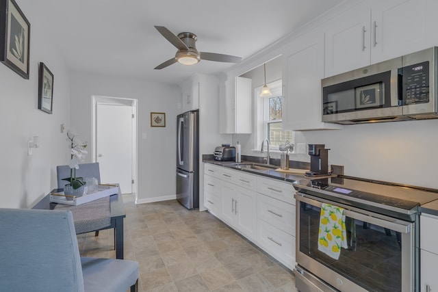 kitchen with pendant lighting, white cabinetry, sink, and stainless steel appliances