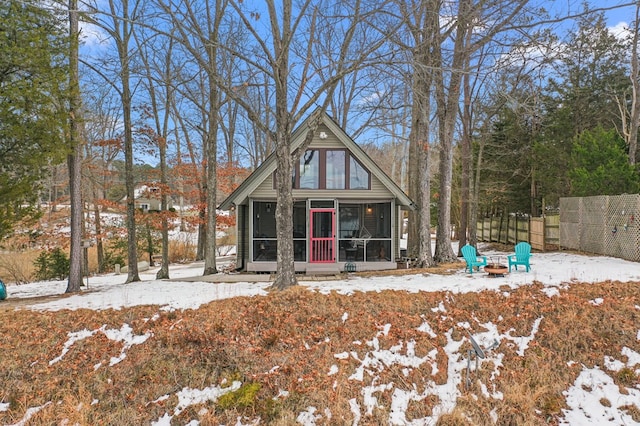 view of front of property featuring a fire pit and a sunroom