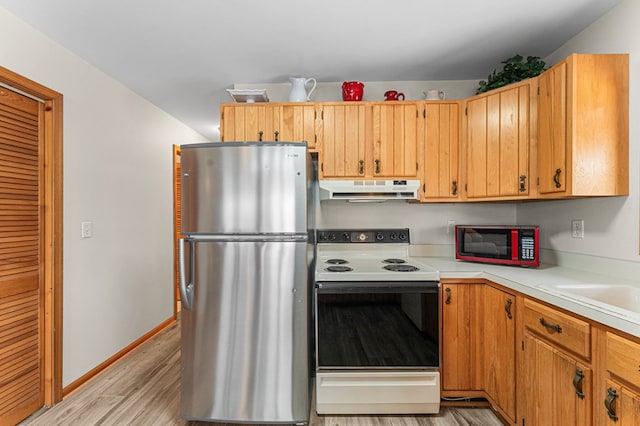 kitchen with light hardwood / wood-style floors, sink, stainless steel fridge, and range with electric stovetop