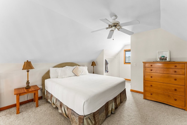 bedroom featuring ceiling fan, lofted ceiling, and light carpet