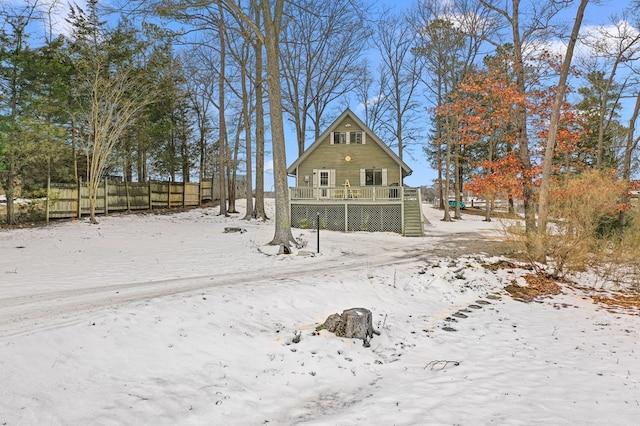 snow covered house featuring a deck