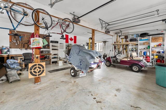 garage with a workshop area and a garage door opener