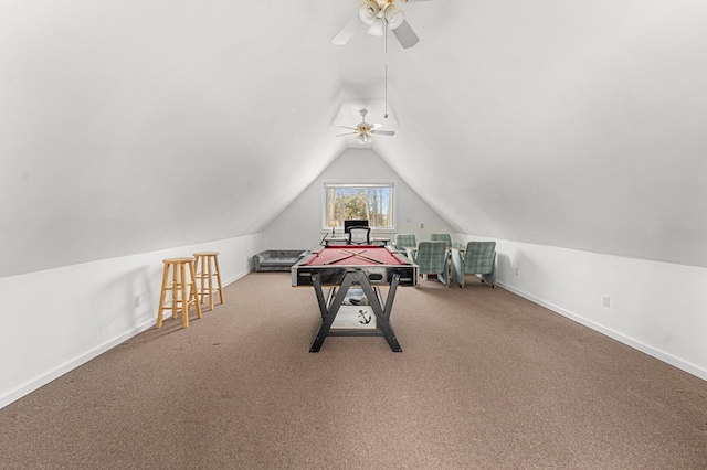 recreation room with carpet floors, ceiling fan, and vaulted ceiling