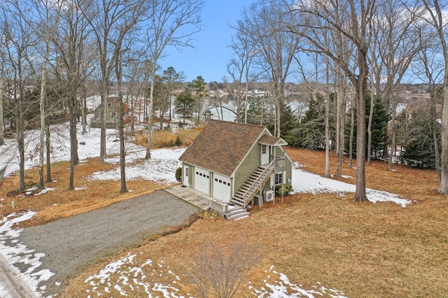 snowy yard with a garage