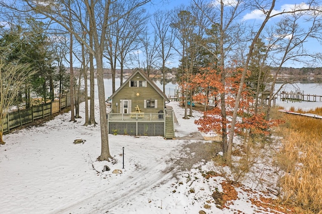 snow covered house with a water view