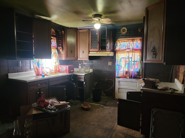 kitchen with light countertops and a ceiling fan