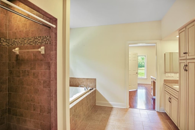 bathroom with plus walk in shower and vanity