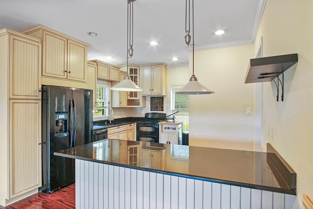 kitchen featuring kitchen peninsula, crown molding, sink, black appliances, and decorative light fixtures