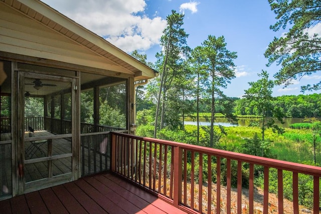 wooden terrace featuring a water view and a sunroom