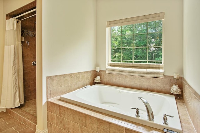 bathroom with shower with separate bathtub and tile patterned floors