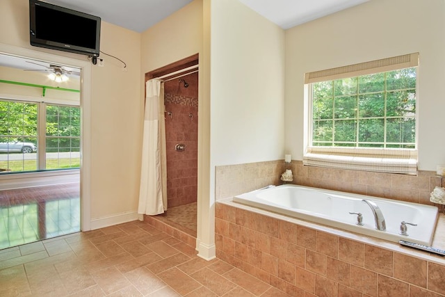 bathroom with shower with separate bathtub and ceiling fan