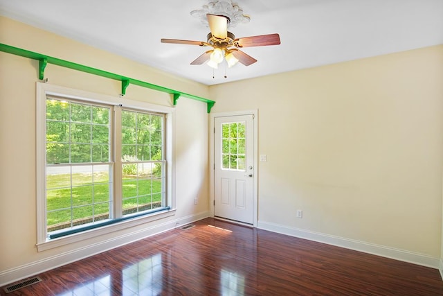 empty room featuring ceiling fan and dark wood-type flooring