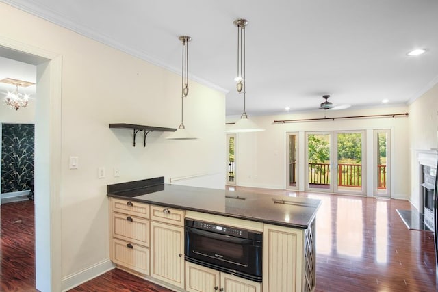 kitchen featuring a high end fireplace, kitchen peninsula, ceiling fan, decorative light fixtures, and black oven