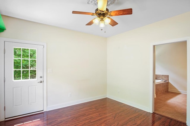 empty room featuring ceiling fan and hardwood / wood-style flooring