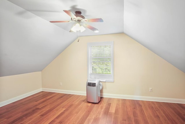 additional living space with lofted ceiling, ceiling fan, and light wood-type flooring