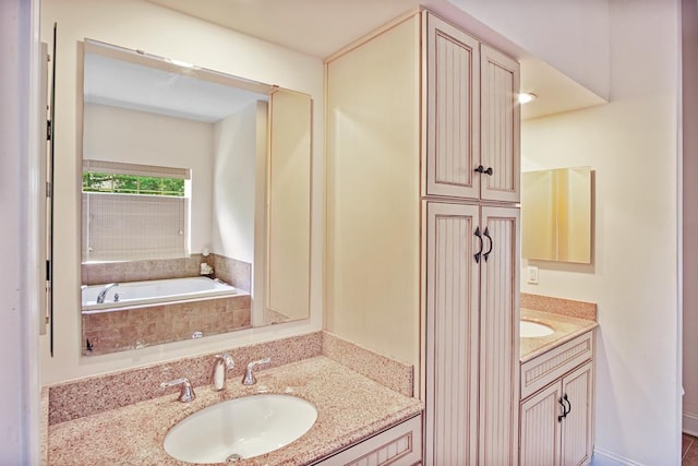 bathroom with vanity and tiled bath