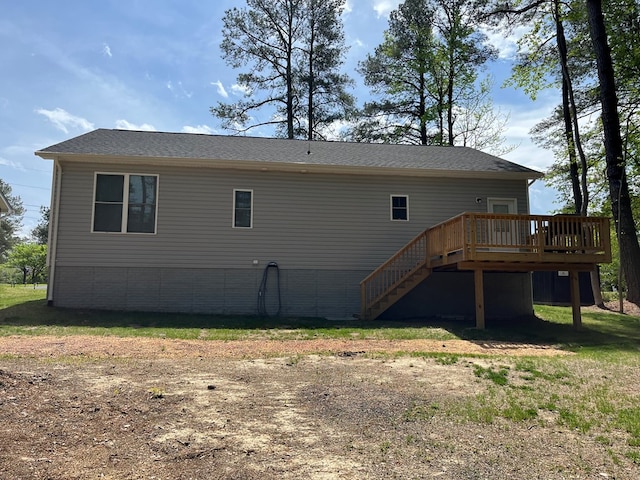 back of property with a deck and stairway