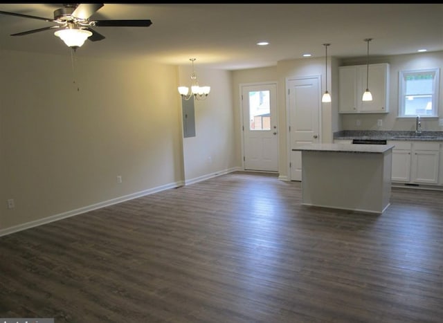 kitchen with white cabinetry, open floor plan, a sink, and recessed lighting