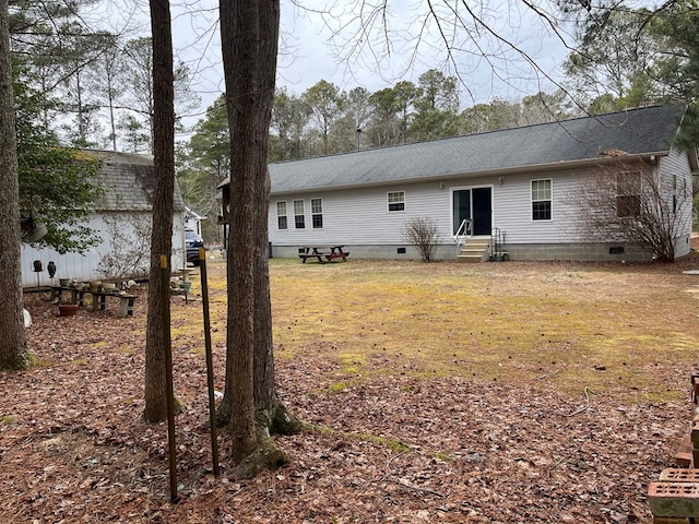 back of house with a lawn