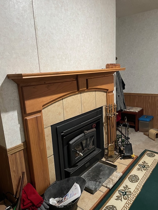 details with carpet, a wood stove, and wood walls