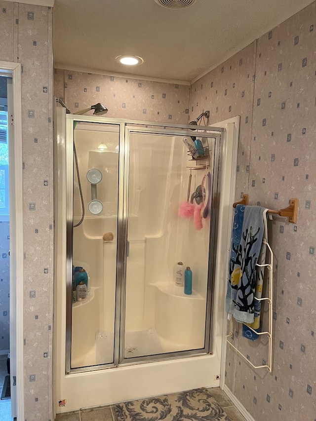 bathroom with a shower with door