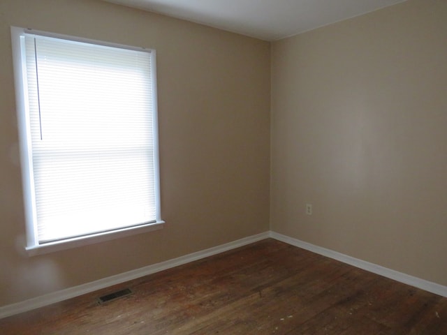 empty room with dark hardwood / wood-style floors