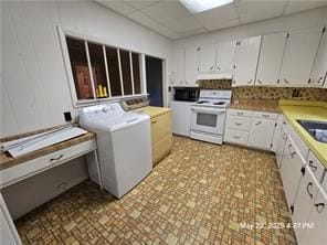 300 Irvington Rd, Kilmarnock, VA 22482 - kitchen featuring white range with electric cooktop, washer / dryer, a drop ceiling, light countertops, and exhaust hood