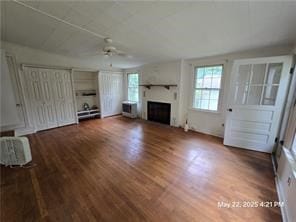 300 Irvington Rd, Kilmarnock, VA 22482 - unfurnished living room with healthy amount of natural light, wood finished floors, a fireplace, and a ceiling fan