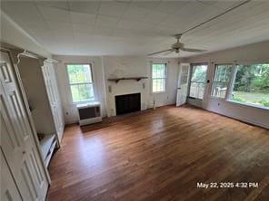 300 Irvington Rd, Kilmarnock, VA 22482 - unfurnished living room with wood finished floors, a fireplace, ceiling fan, and decorative columns