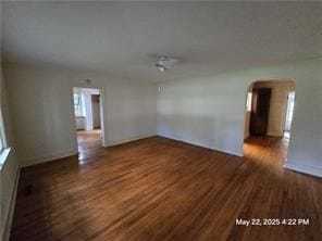 300 Irvington Rd, Kilmarnock, VA 22482 - spare room with arched walkways, wood finished floors, and baseboards