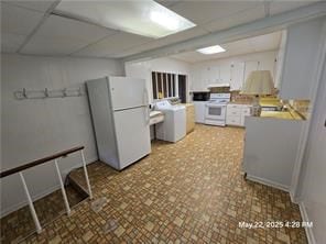300 Irvington Rd, Kilmarnock, VA 22482 - kitchen featuring white appliances, light countertops, a paneled ceiling, and washer / dryer